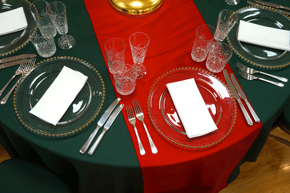Green Essential table linen, Red Berry Taffeta runner, Cut Crystal glasses, Gold Beaded charger plates with White Essential napkins