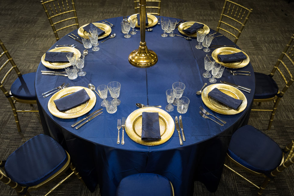 Midnight Blue Taffeta table linen, Cut Crystal glasses, French Navy Vintage Damask napkins paired with Gold Starburst charger plates, Gold Chiavari Chairs with Midnight Blue Taffeta pads at 200 SVS, Image courtesy of First Light Photography