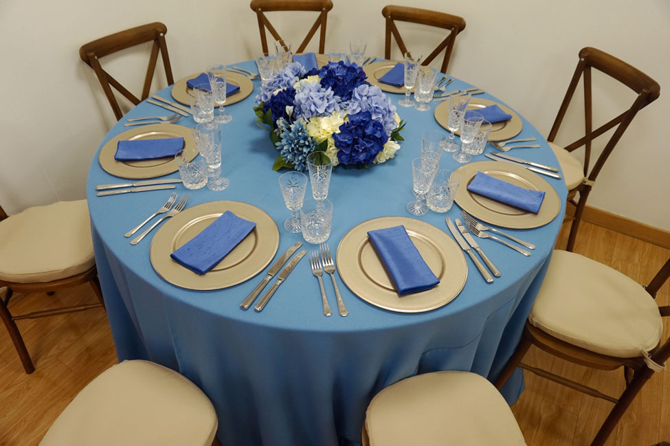 Wedgewood Essential table linen, Crossback Chairs with Biscuit Essential seat pads, Cut Crystal glasses, Latte charger plates paired with Electric Blue Faux Silk napkins