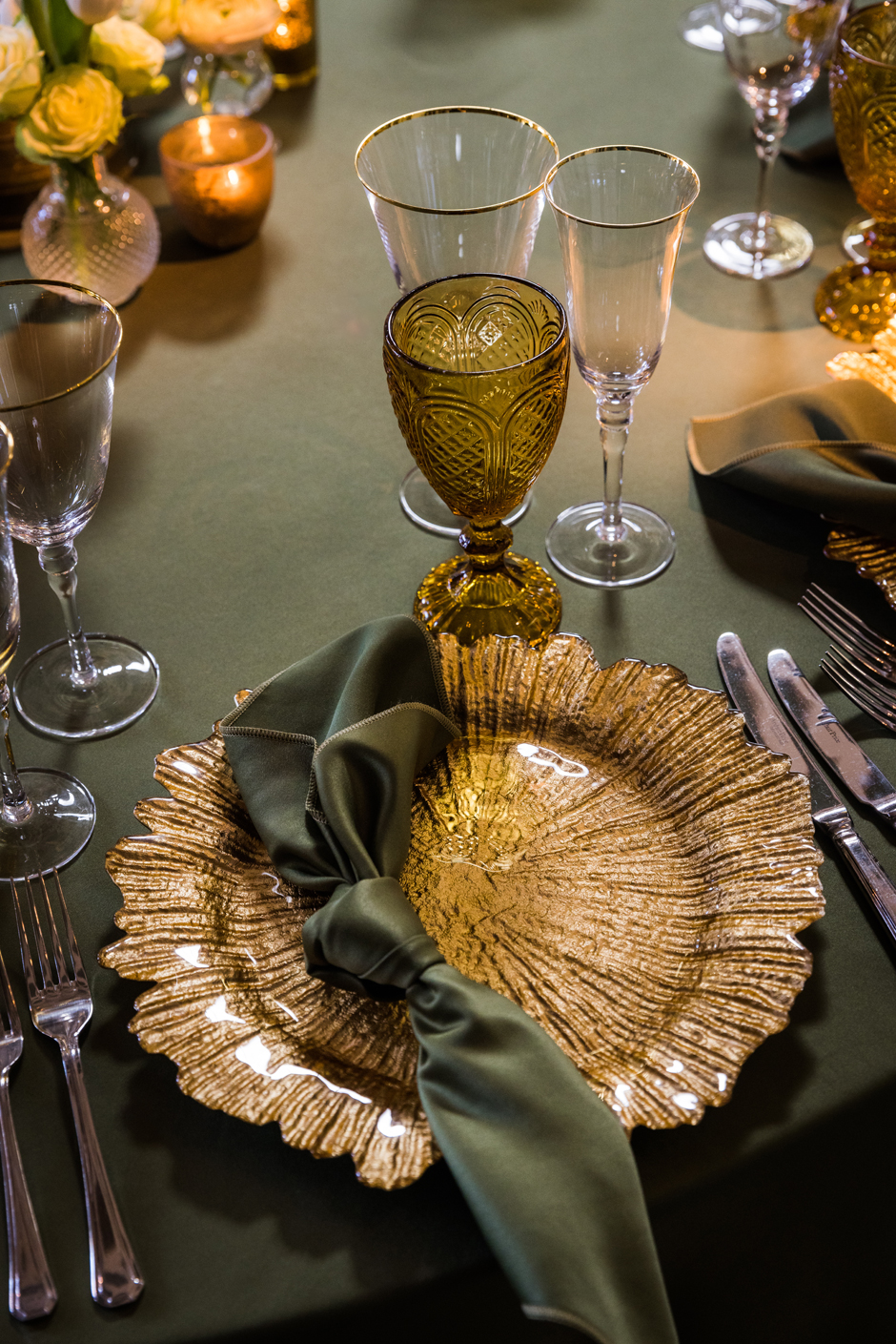 Gold petal charger plate with moss Verona satin linen, gold trim glasses & amber goblet