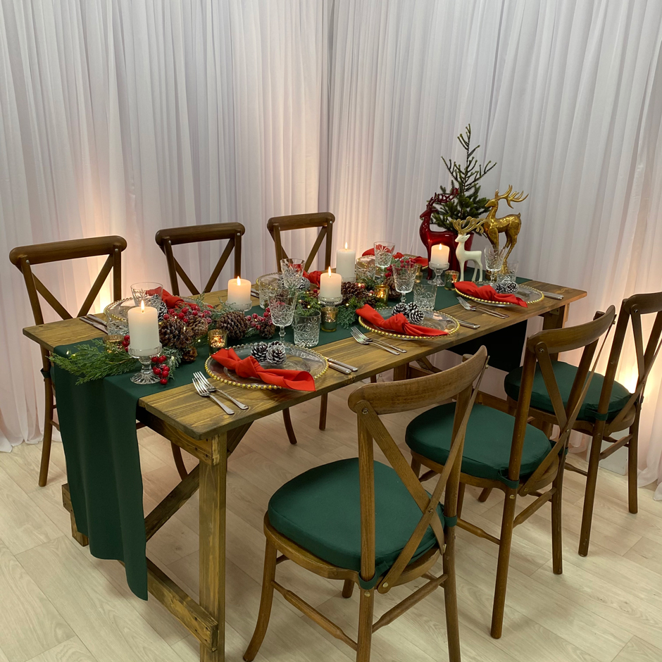 Styling features: Crossback chairs w/green Essential pads, green Essential runner, red Essential napkins, gold Beaded chargers & Cut Crystal glasses.