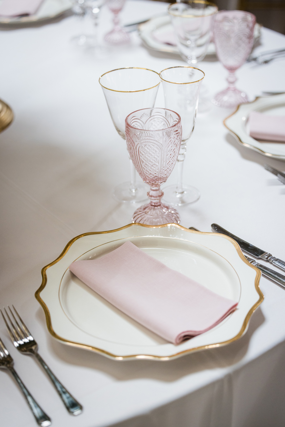 Gold trim Porcelain charger plate with white Essential linen, peony Gelato napkin, gold trim glasses & pink goblet.