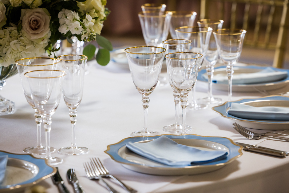 Gold trim glasses with white Essential linen, powder blue Verona napkin & Blue porcelain charger plate